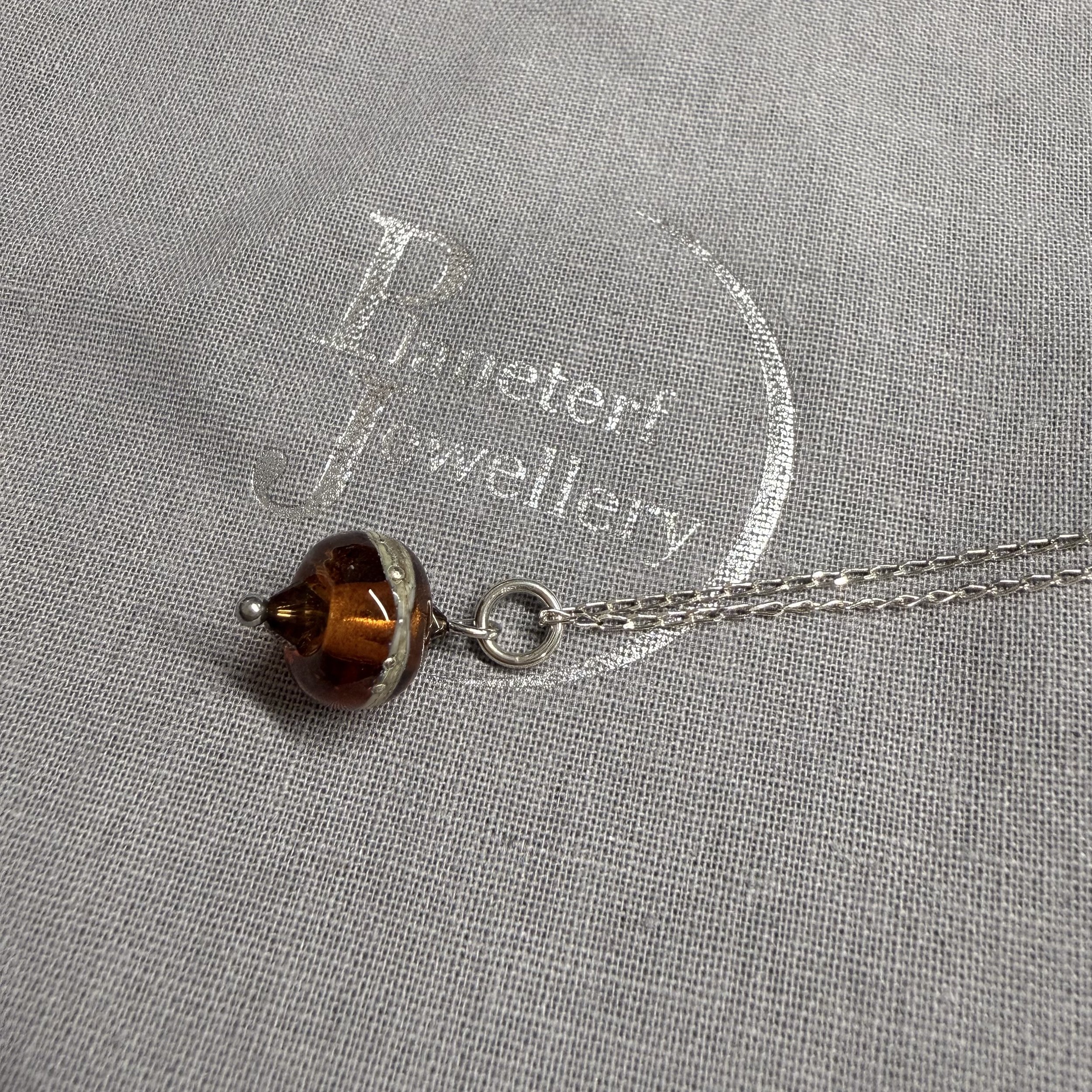 Amber coloured lampwork bead on sterling silver chain