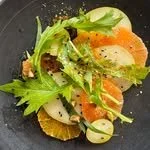 Salad with mixed greens, smoked salmon, sliced radishes, and peppercorns