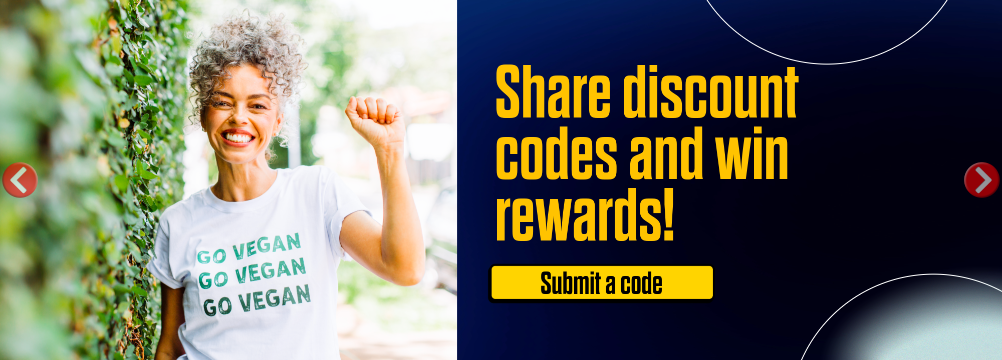 A woman with curly gray hair smiling and raising her fist, wearing a white t-shirt that says 'GO VEGAN' multiple times. The background shows greenery and a sunny outdoor environment.