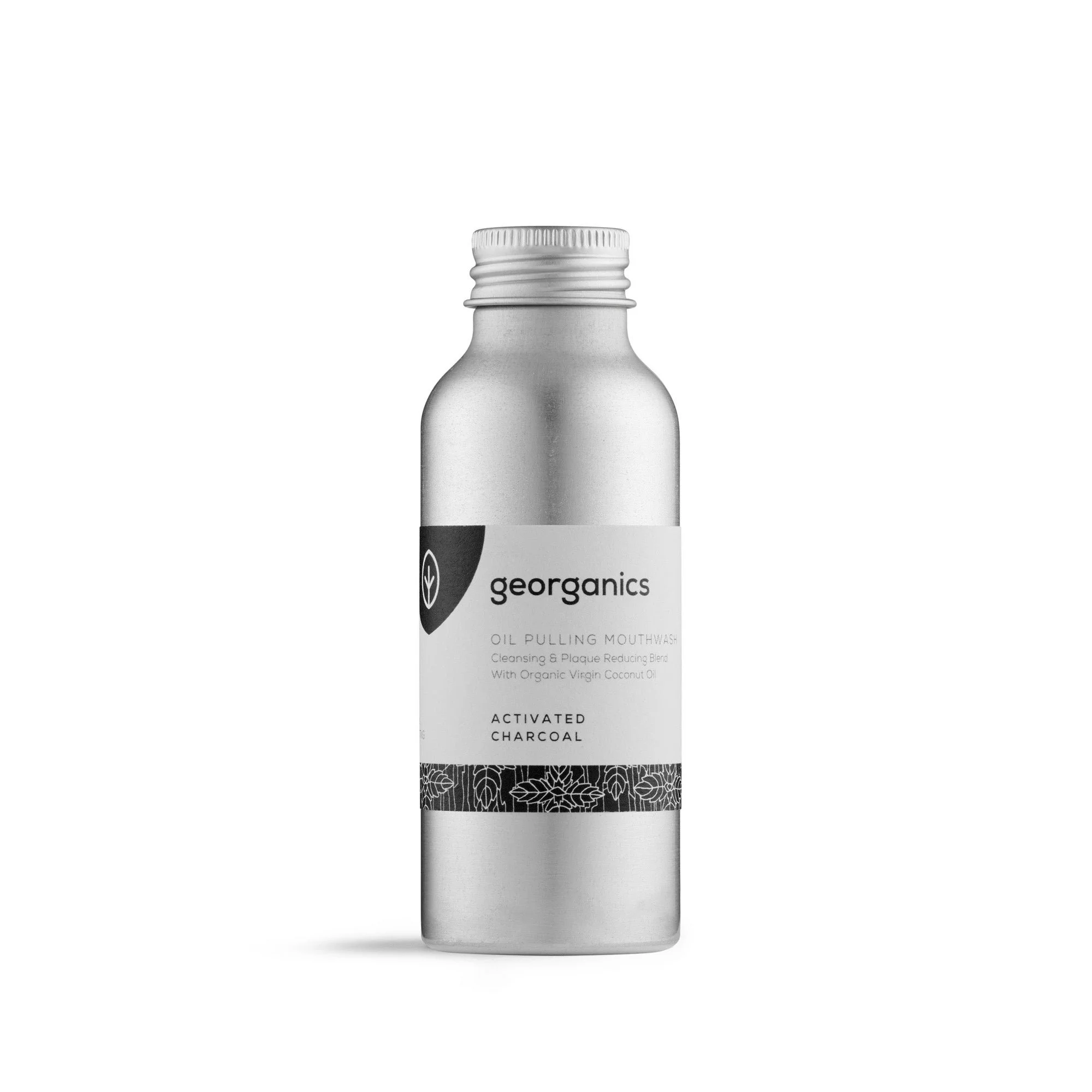 Silver bottle of Georganics activated charcoal oil pulling mouthwash with organic virgin coconut oil, with a black label and decorative floral pattern at the bottom.