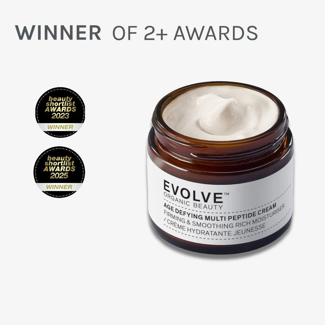 Open jar of EVOLVE Organic Beauty Age Defying Multi Peptide Cream with awards badges on left and text above