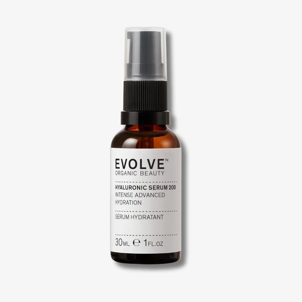 A brown glass bottle of EVOLVE Organic Beauty Hyaluronic Serum 200 with a clear spray top and a white label.