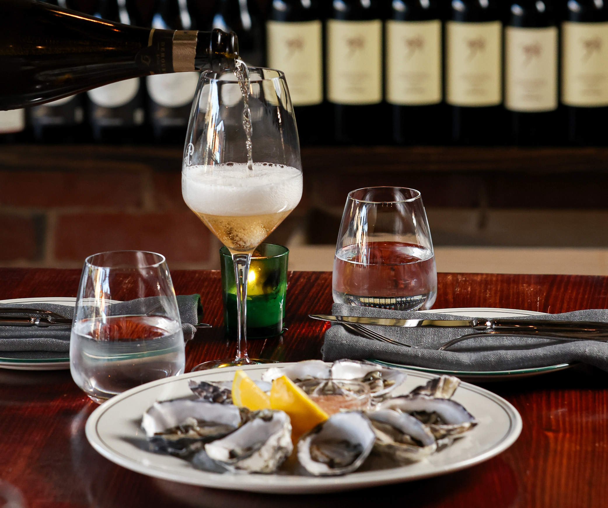 Ruckers Hill Wine Dinner - image of wine poured into a glass with oysters