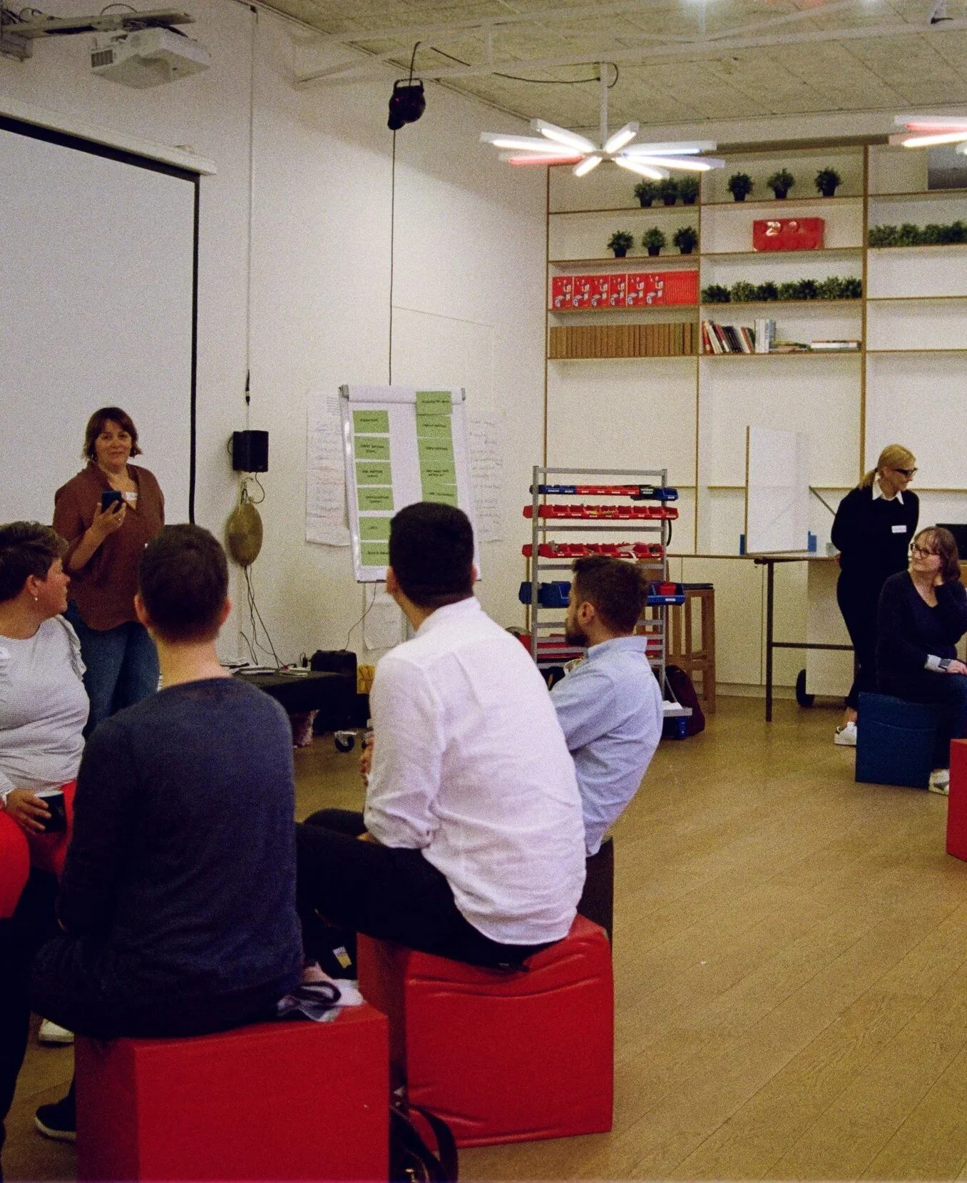 Patient advocates sitting in a circle on red cubes at a European Patients Forum workshop