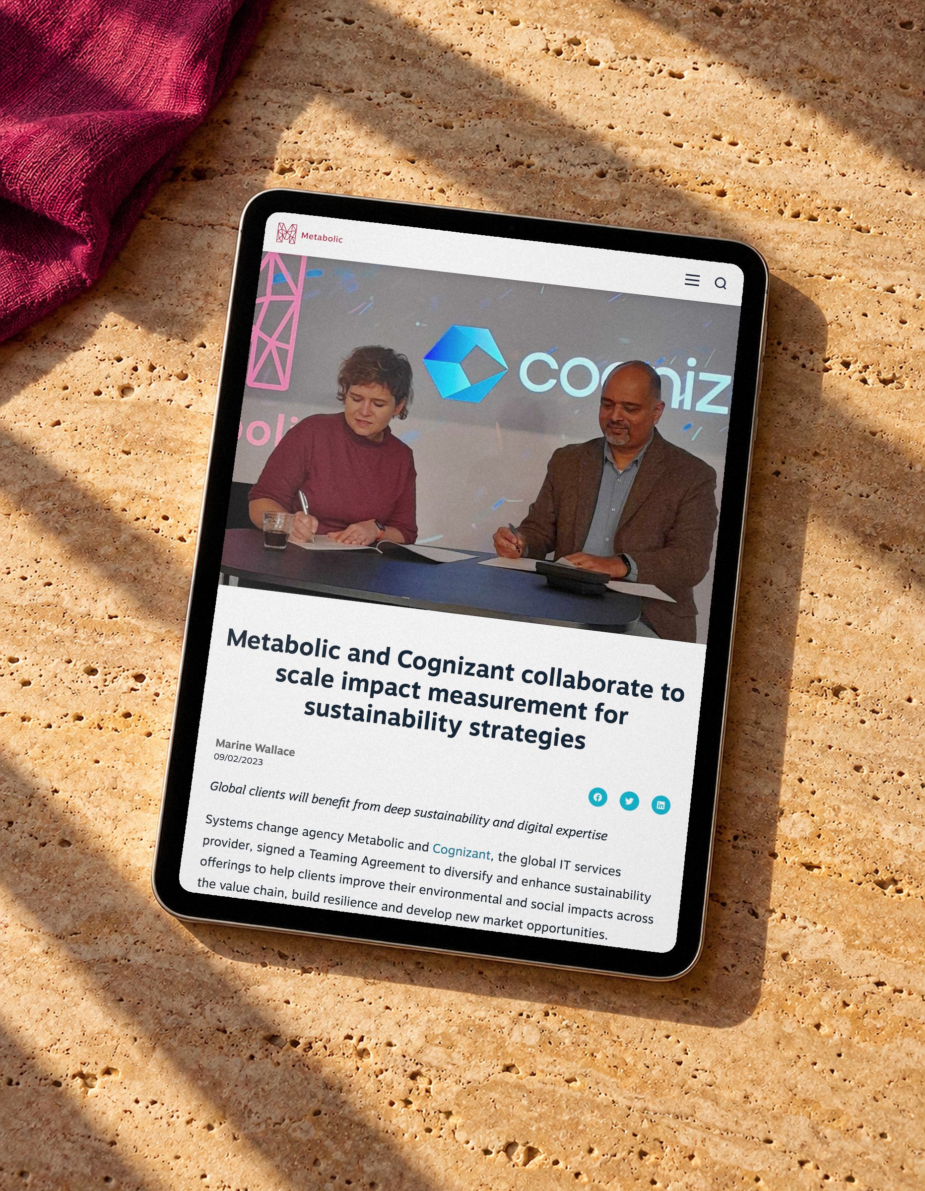 Metabolic's news post on its partnership with Cognizant, on a tablet lying on travertine