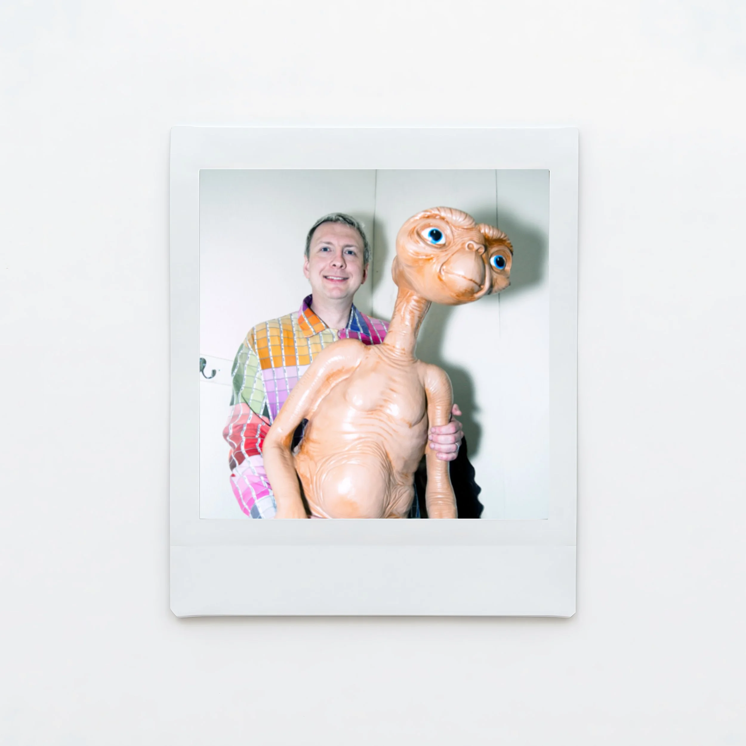 A male comedian Joe Lycett wearing a colourful shirt and next to a model of E.T and a cardboard cutout of Cher photographed backstage at the Crookes Socila Club Sheffield Karina Lax at The Comedy Village, Sheffield