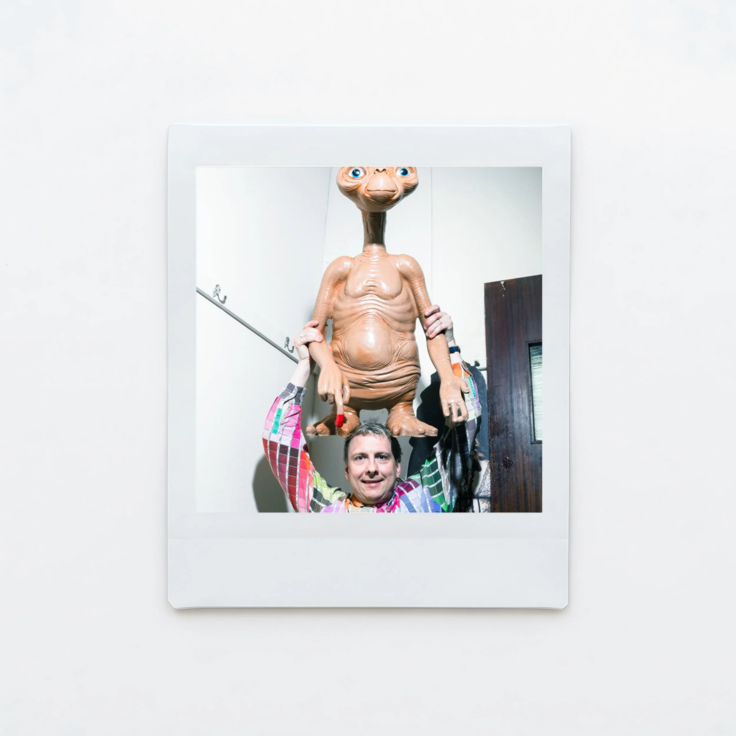 A male comedian Joe Lycett wearing a colourful shirt and next to a model of E.T and a cardboard cutout of Cher photographed backstage at the Crookes Socila Club Sheffield Karina Lax at The Comedy Village, Sheffield