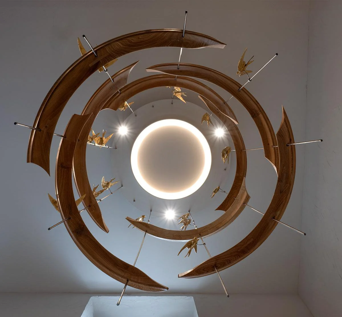 Bespoke Suspended Lighting Sculpture

A large-scale suspended sculpture designed to work with the architecture and lighting of the space. Sweeping hardwood curves, polished metal rods and gilded bird details create a sense of movement, drawing the ey