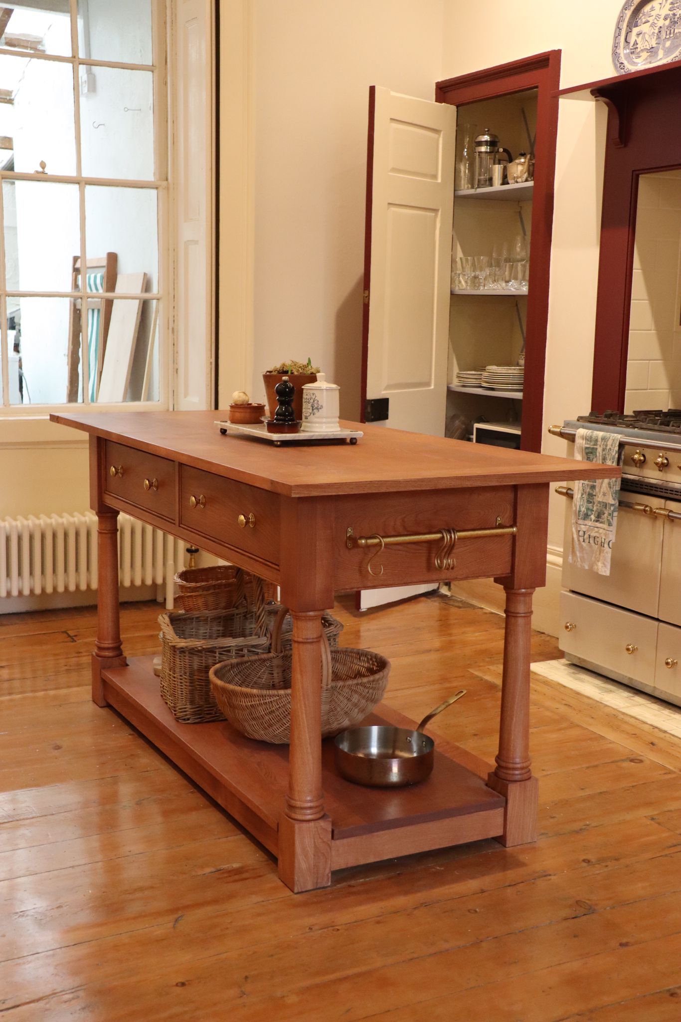 Bespoke Freestanding Kitchen Island

A handmade freestanding kitchen island, crafted in solid timber with turned legs, drawers, brass fittings and a lower storage shelf. Designed to suit a traditional kitchen, it adds practical workspace, storage and