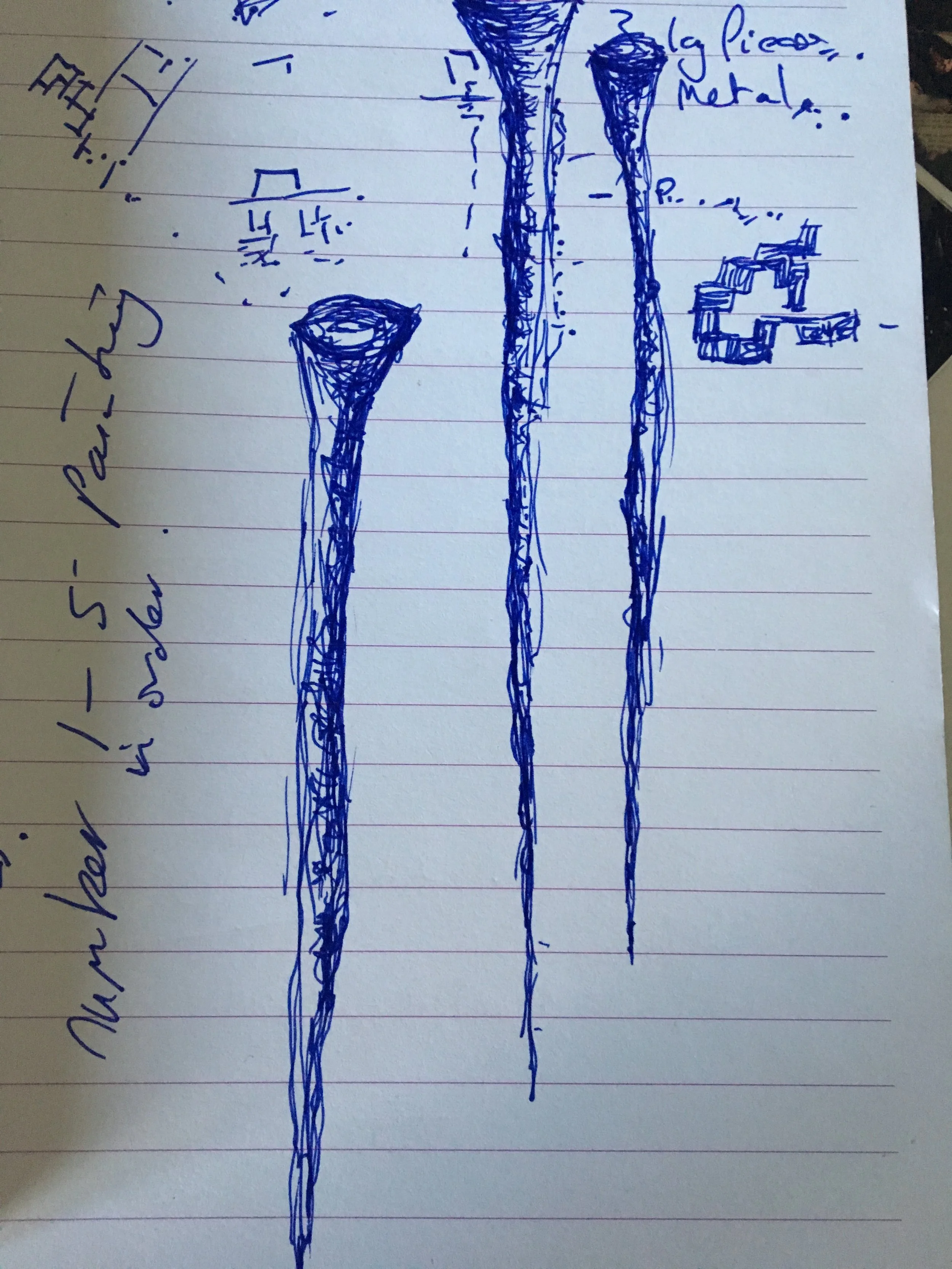 Hand-drawn sketches in blue ink on lined paper showing various shapes and structures, including elongated cones, square shapes, and a rectangular shape with multiple steps. Handwritten notes in blue ink accompany the sketches.