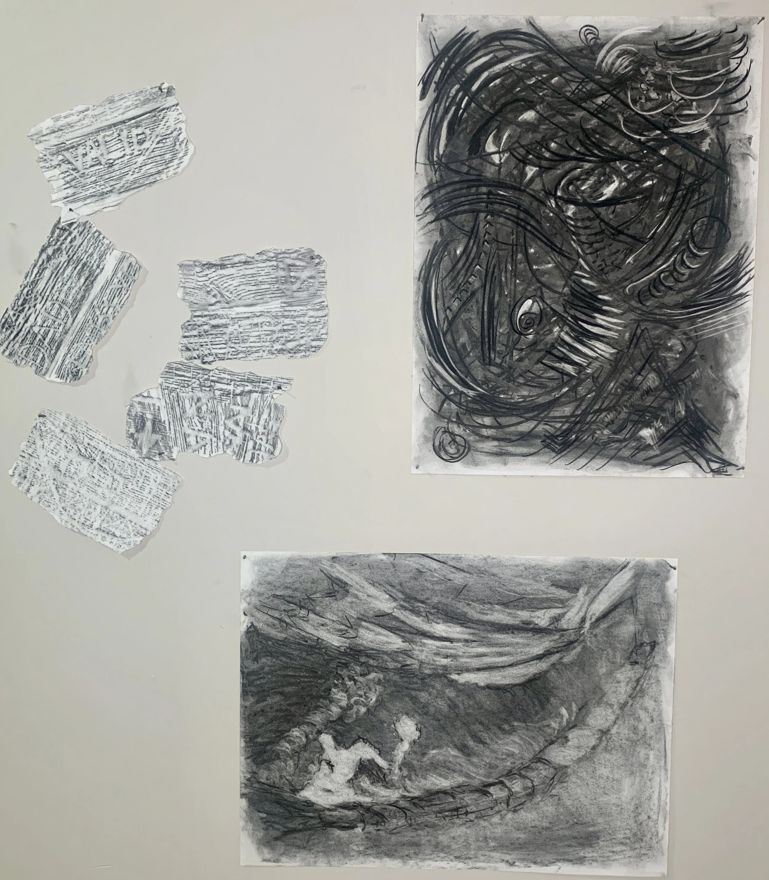 Several torn pieces of paper with text and patterns on a white background, and two larger abstract black and white drawings or paintings featuring swirling lines and textures.