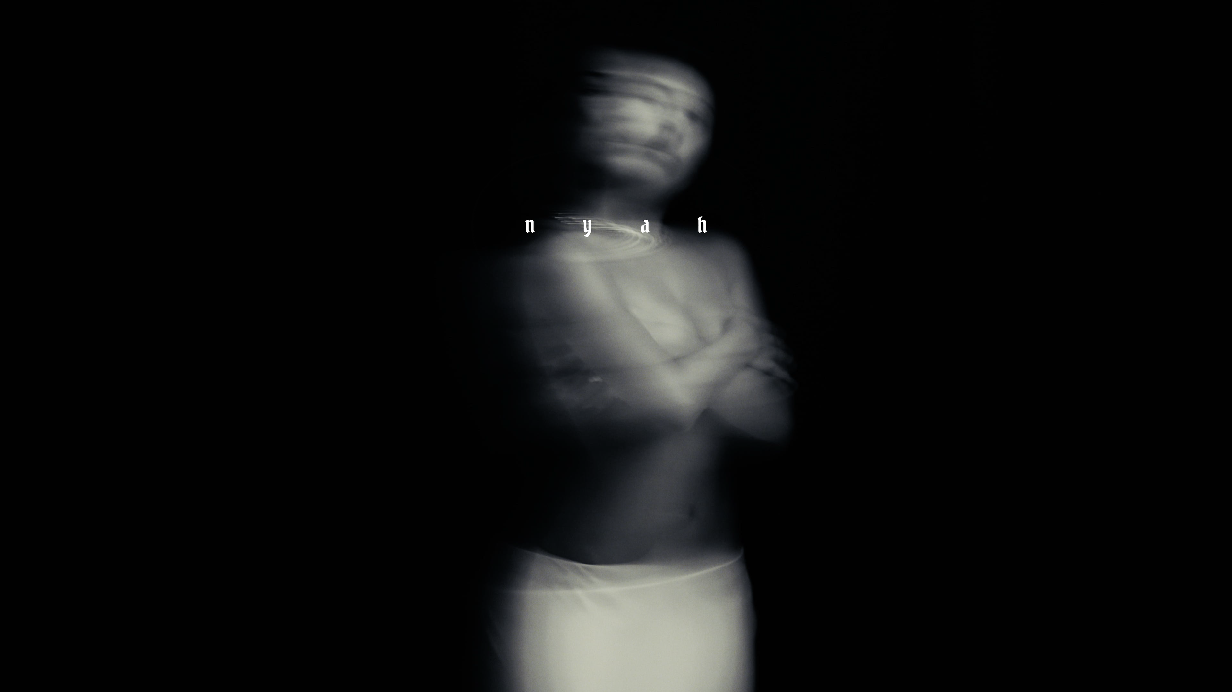 Blurred black-and-white photo of a woman with arms crossed, with the name 'Niyah' in stylized text in front of her.