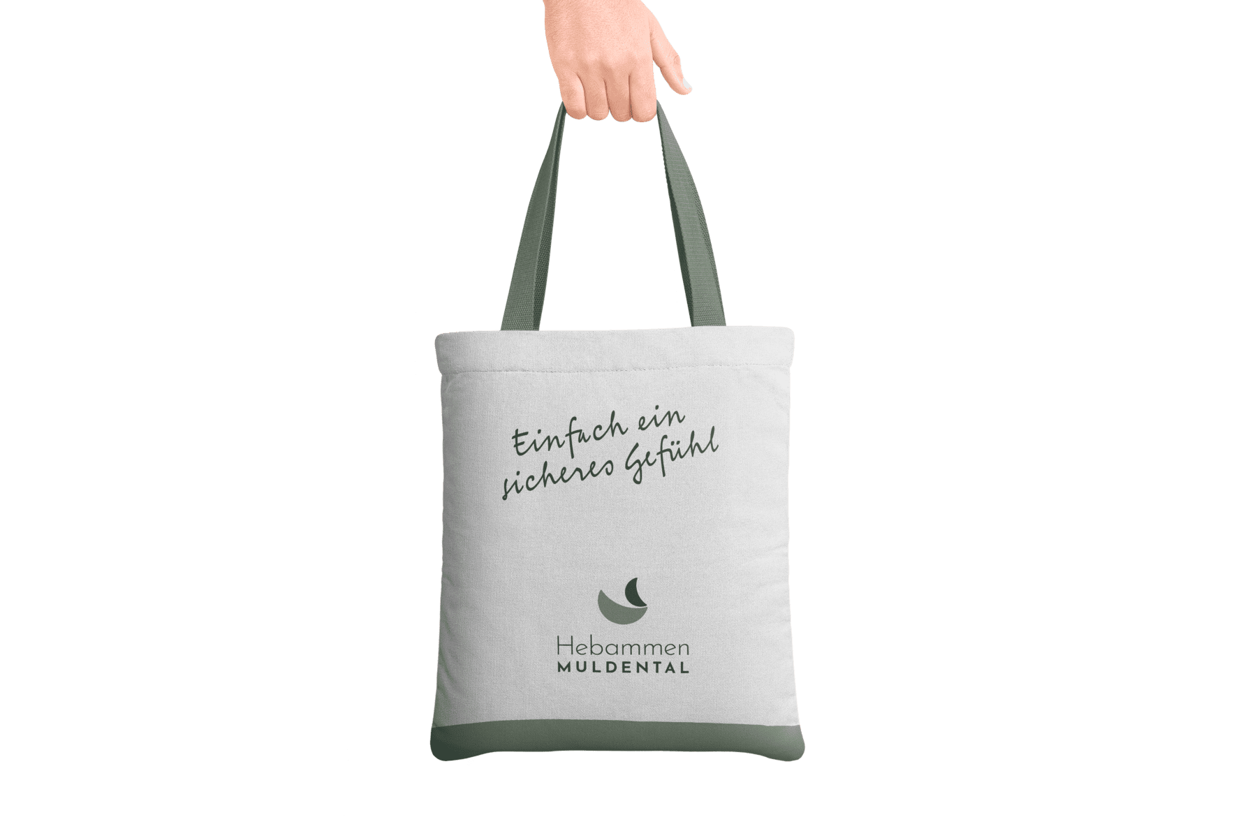 Mockup einer weißen Einkaufstasche mit grünem Rand, dem Logo der Hebammen Muldental und dem Spruch "Einfach ein sicheres Gefühl"