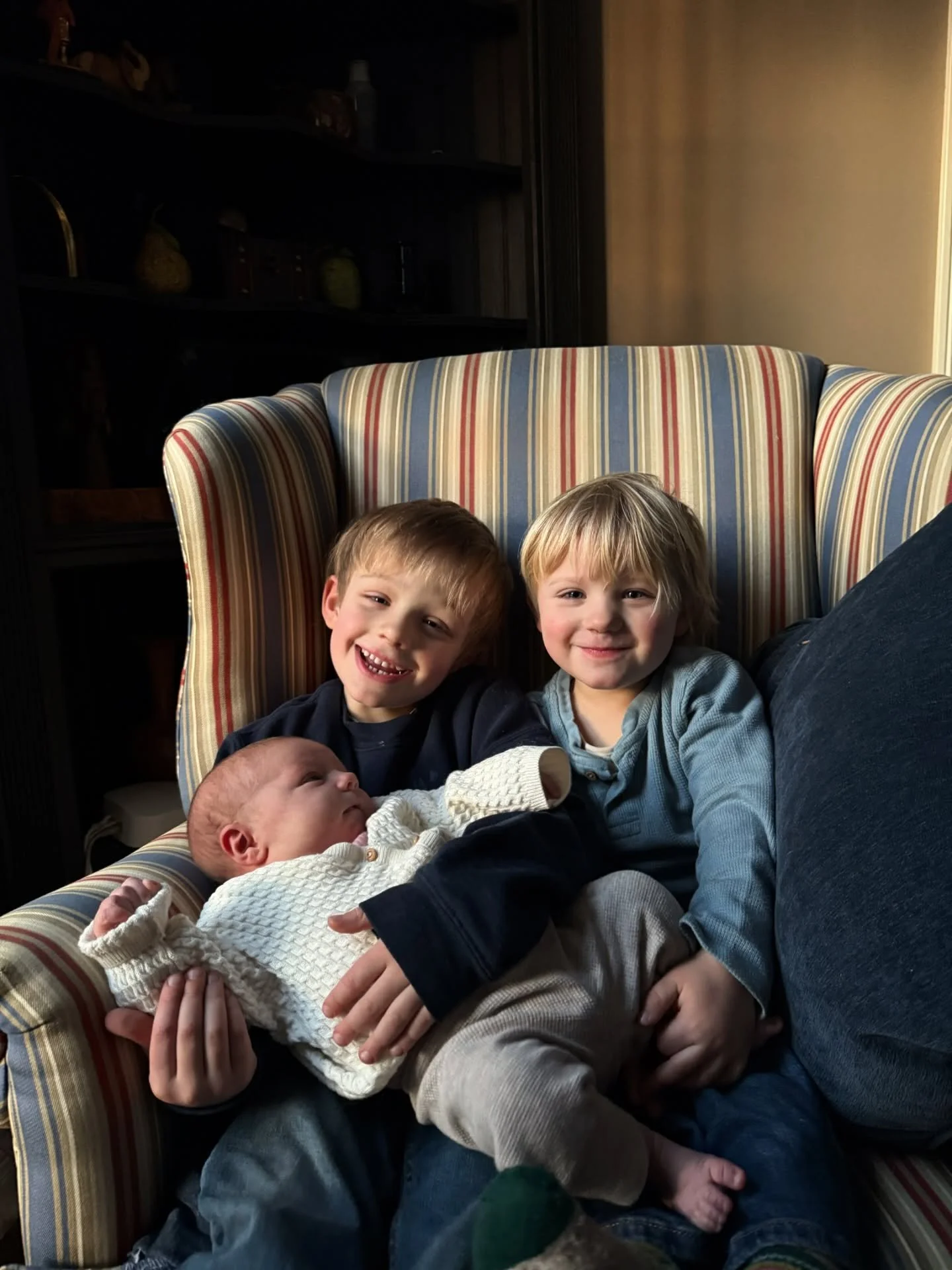 these moments, these kiddos. I did ask them all to sit there and monitored the baby-holding situation, but other than that, this is not a staged moment. the lighting is natural, the kiddos are in their regular clothes, and their personalities are all