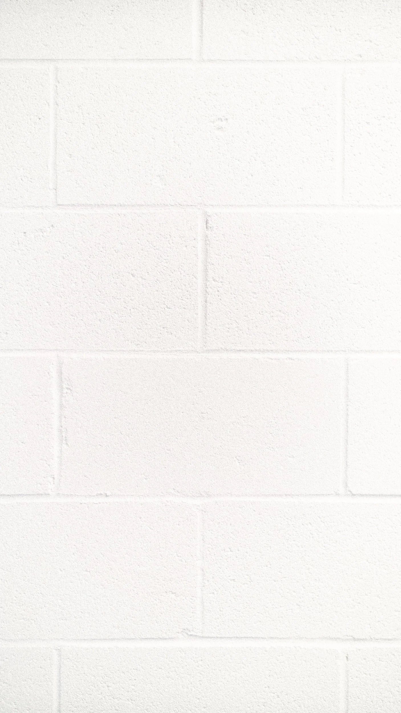 White painted brick wall.