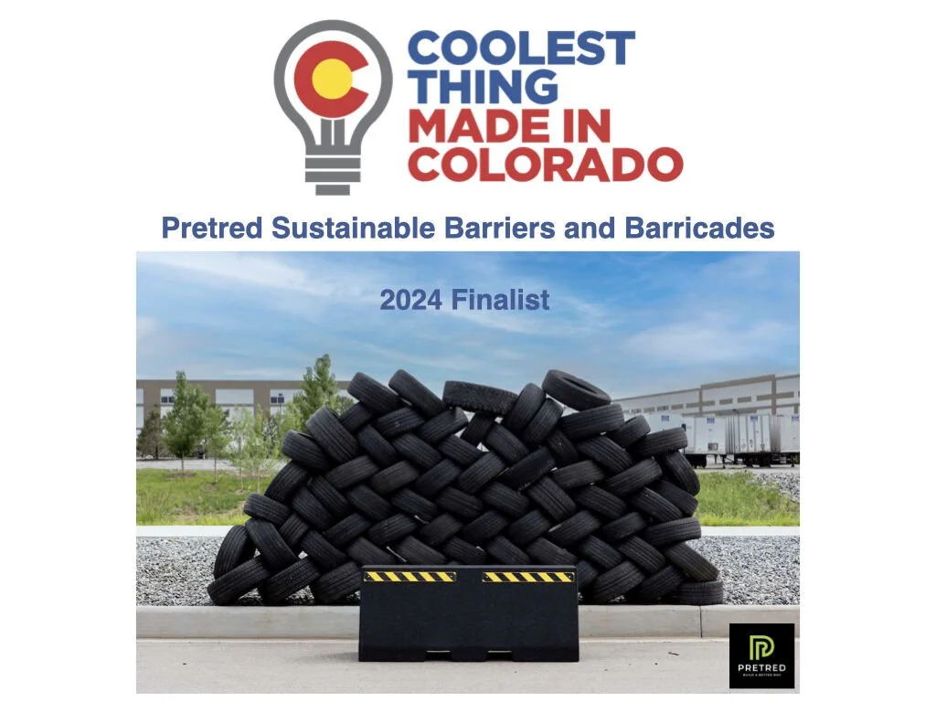 A large pile of black tires used as pretended sustainable barriers or barricades, with a black barricade in front, set outdoors with buildings, trees, and train tracks in the background, under a partly cloudy sky, promoting a 2024 finalist project in Colorado.
