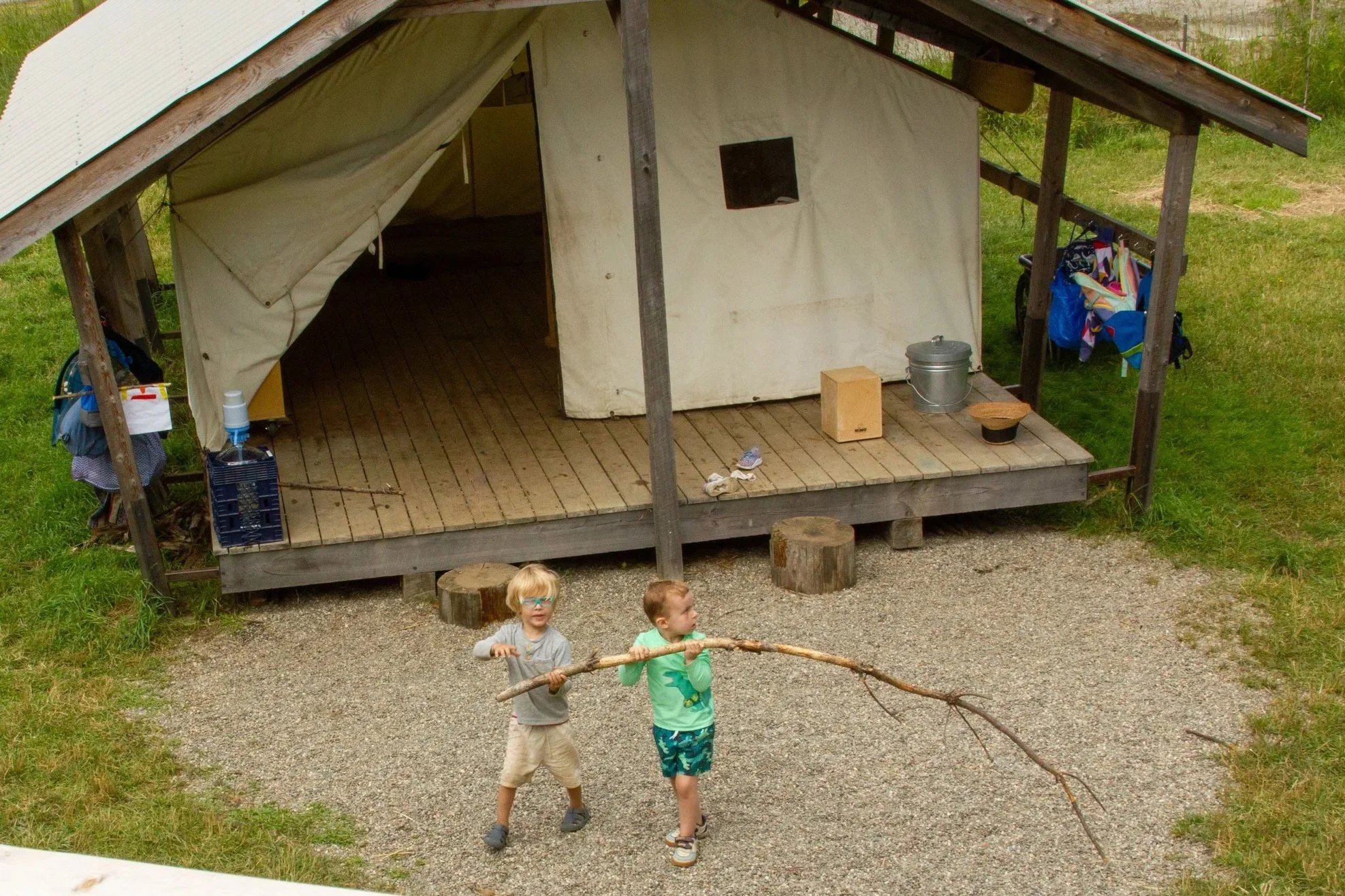 Humble Heart camp has a beautiful play tent set up as a classroom with wooden tables, chairs, educational toys, and a wood-burning stove.