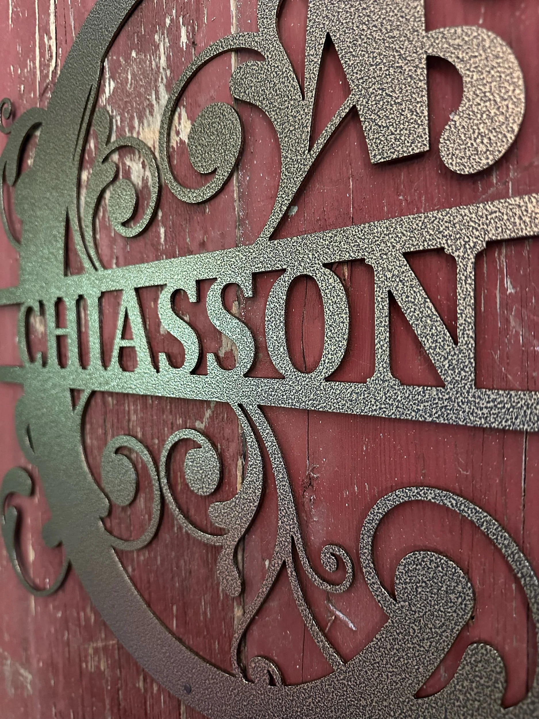 Chiasson Smoke metal sign hanging on a wall