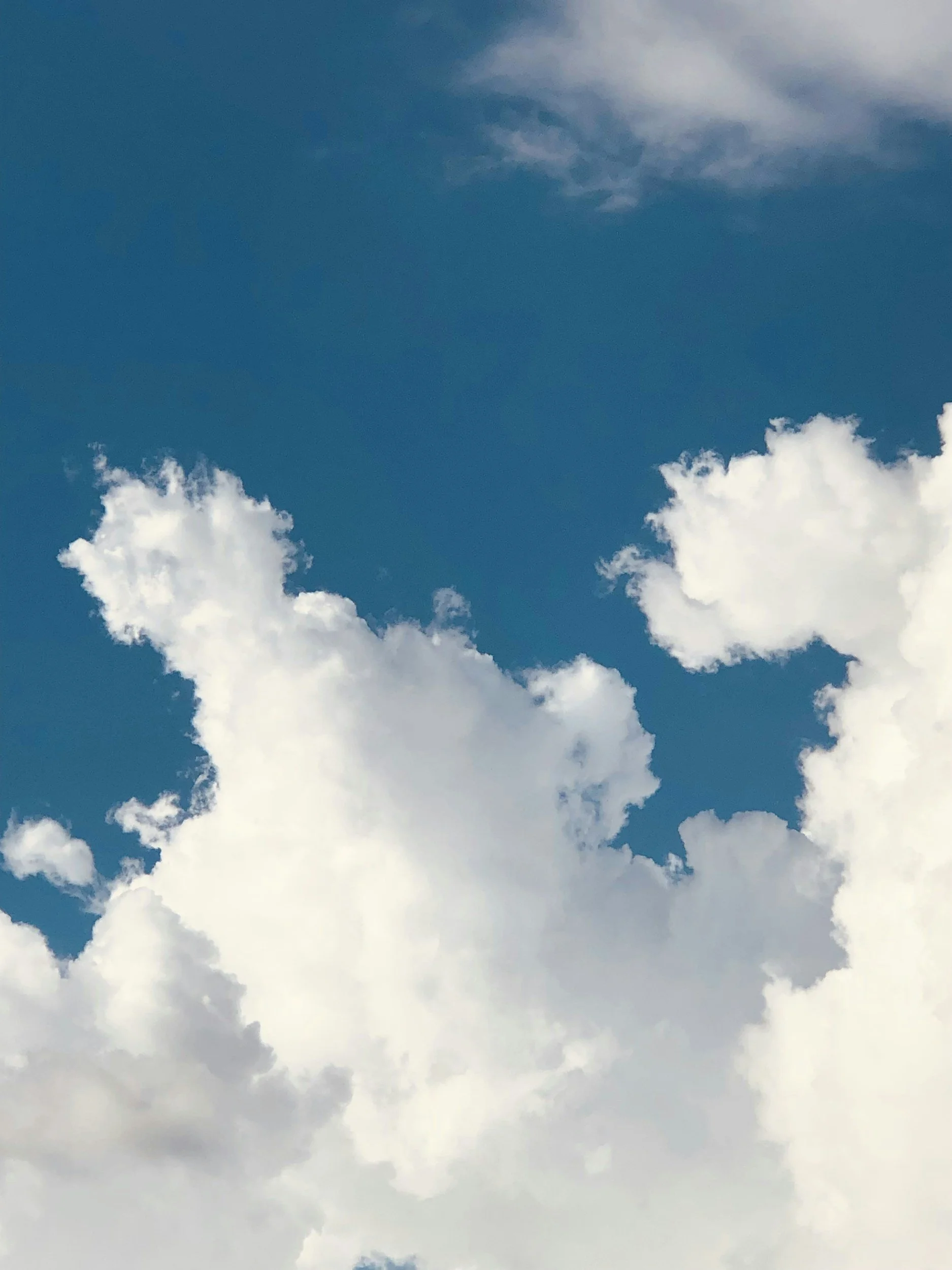 Puffy white clouds against a blue sky