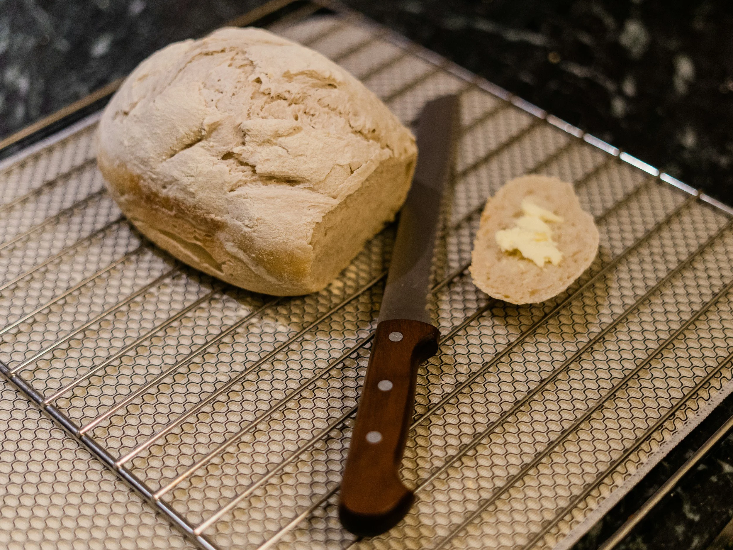 Fresh homemade bread on an oven grate