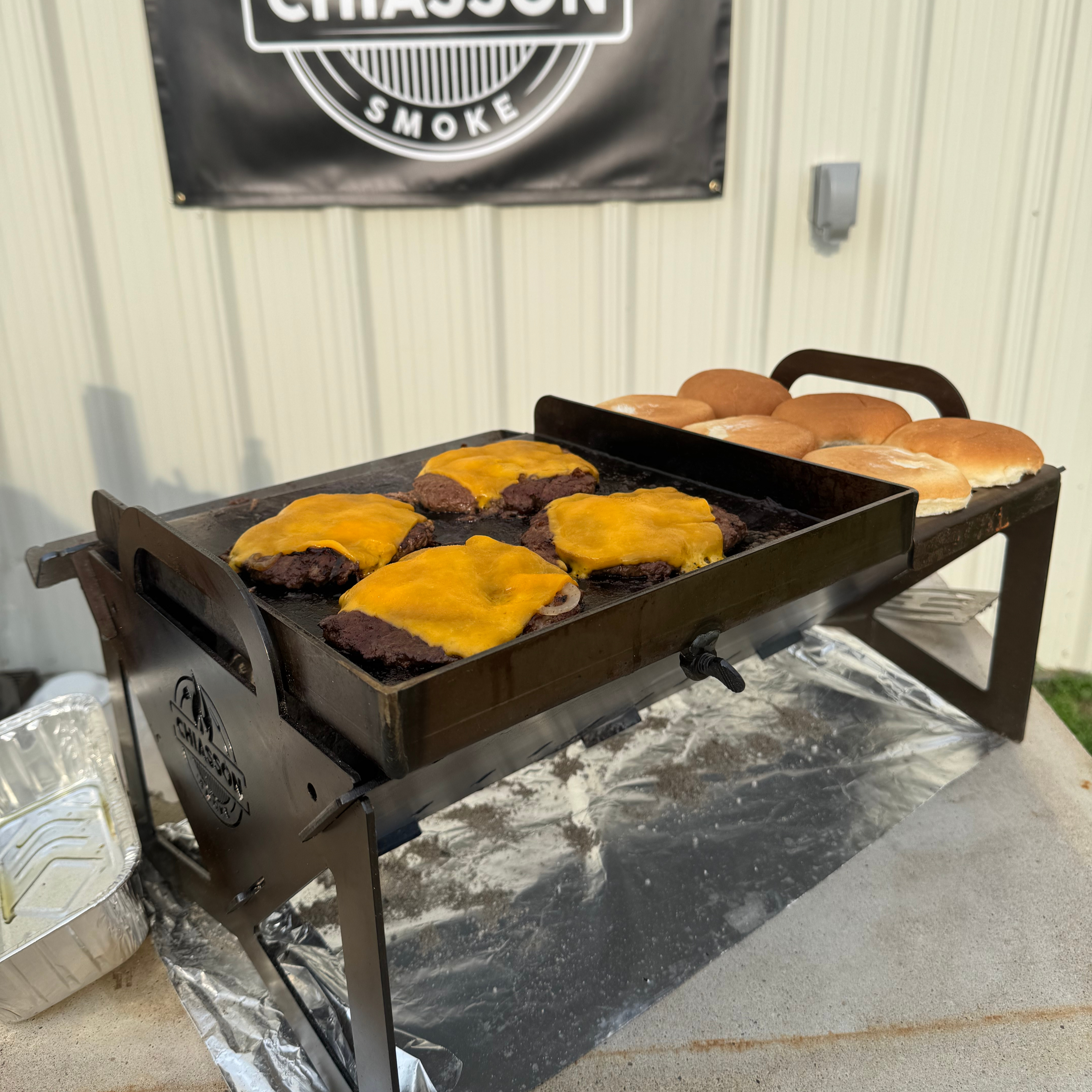 Chiasson Smoke Hauler grill with cheeseburgers on top
