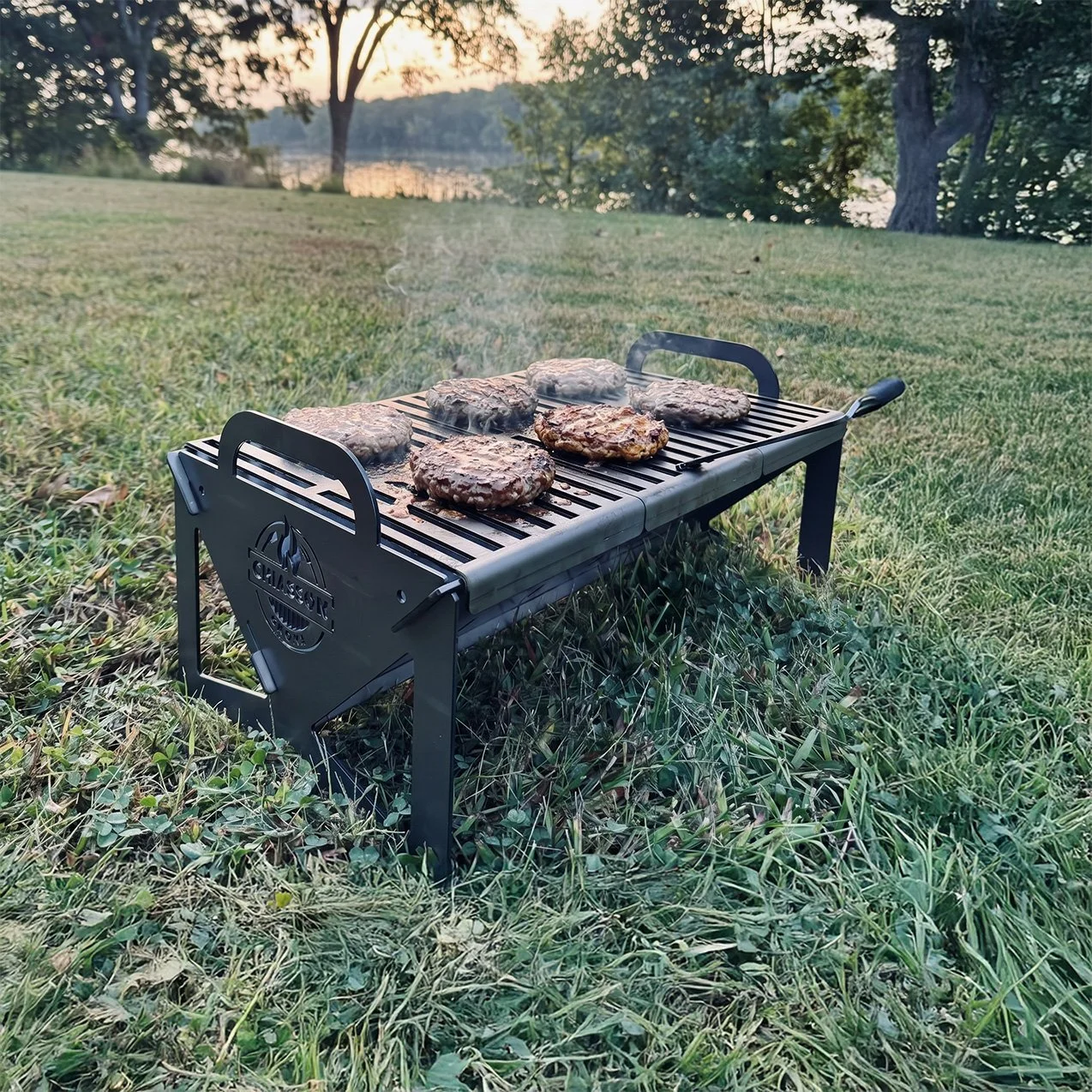 Burgers grilling on a portable charcoal grill