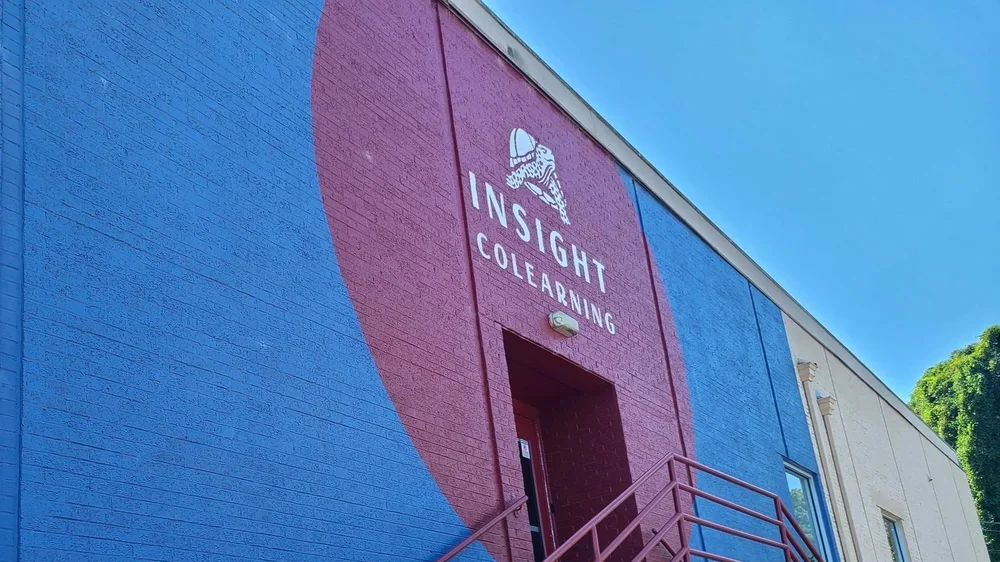 Exterior of a colorful building with a mural and the text 'INSIGHT COLEARNING' on the wall.