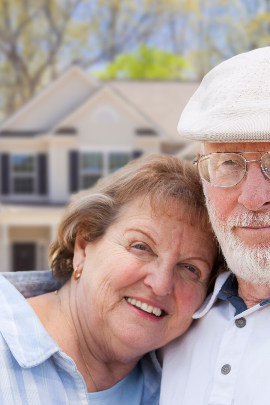 Couple in front of amily home representing asset protection and advance Medicaid planning for North Carolina seniors concerned about nursing home costs.