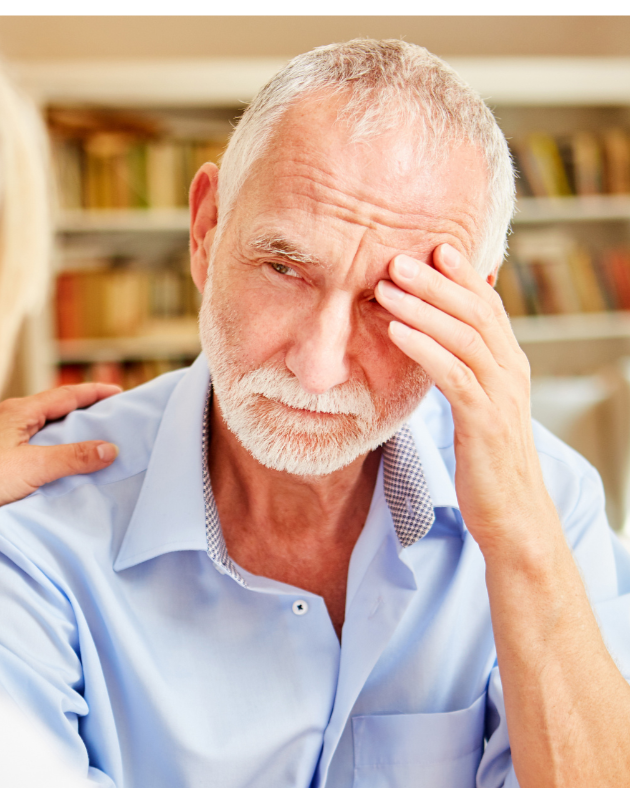 An adult child comforting an aging parent experiencing memory loss, representing the challenges families face when guardianship may become necessary in North Carolina.