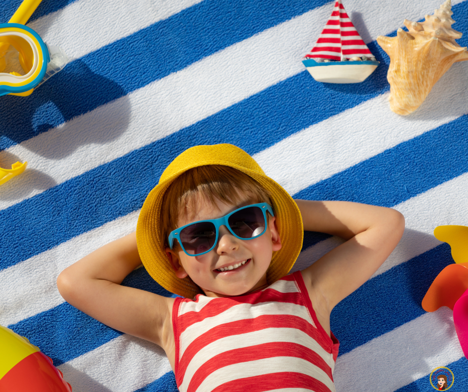 Child relaxing on a beach towel with summer vacation items, reminding parents to include guardianship planning before traveling with or without children.