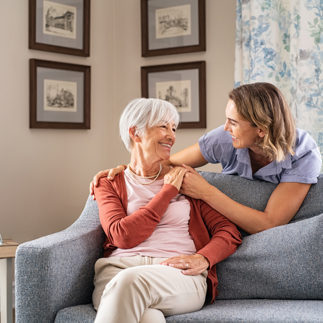 daughter holding hands with mom who is sitting down in front of her; garner elder law attorney; mackintosh law; the happy lawyer; asset protection; mediciad