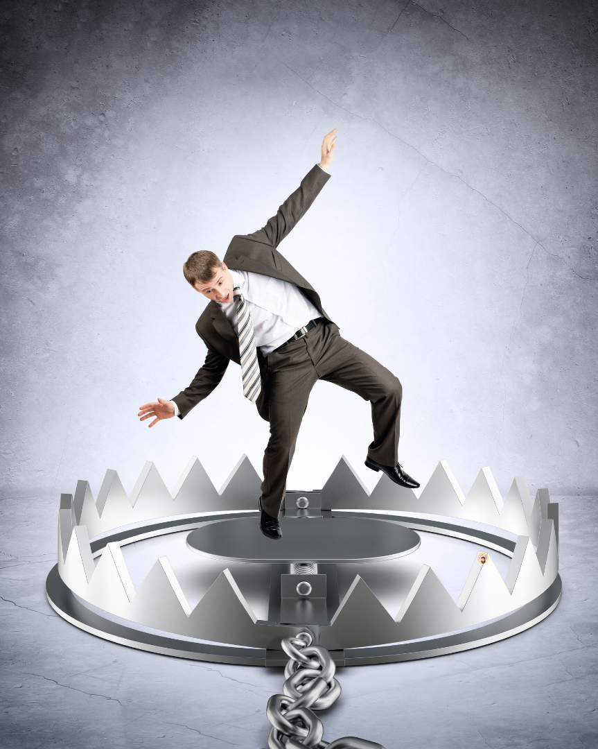 Businessman stepping into a trap symbolizing common estate planning mistakes made by married couples in North Carolina.