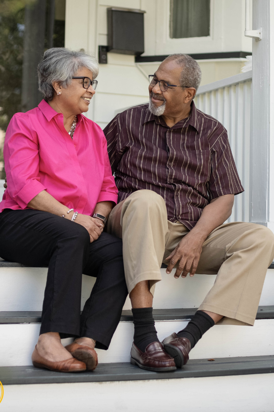 Older North Carolina couple sitting on front porch of home discussing how to protect their house from nursing home costs and plan for long-term care.