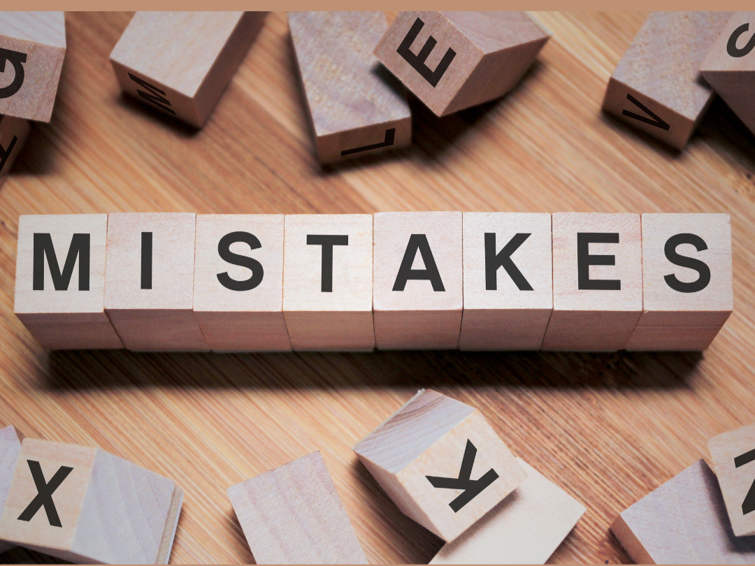Wooden blocks spelling mistakes representing common estate planning errors made by married couples in North Carolina.