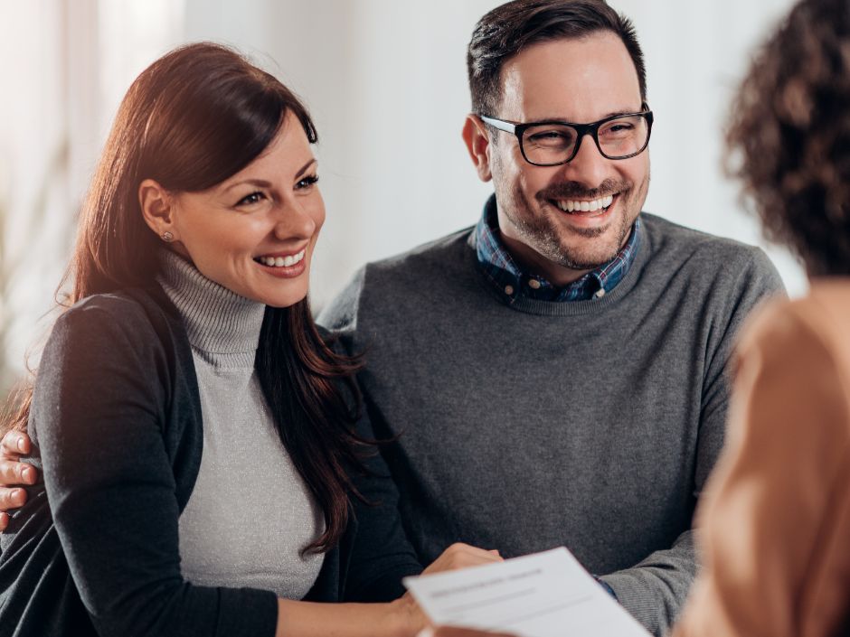 smiling couple meeting with estate planning attorney to create a plan to avoid probate