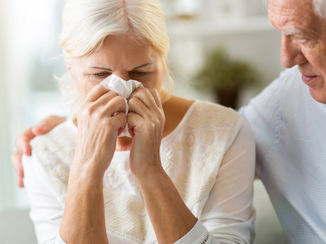 Older North Carolina couple experiencing emotional stress related to Medicaid planning and long-term care costs