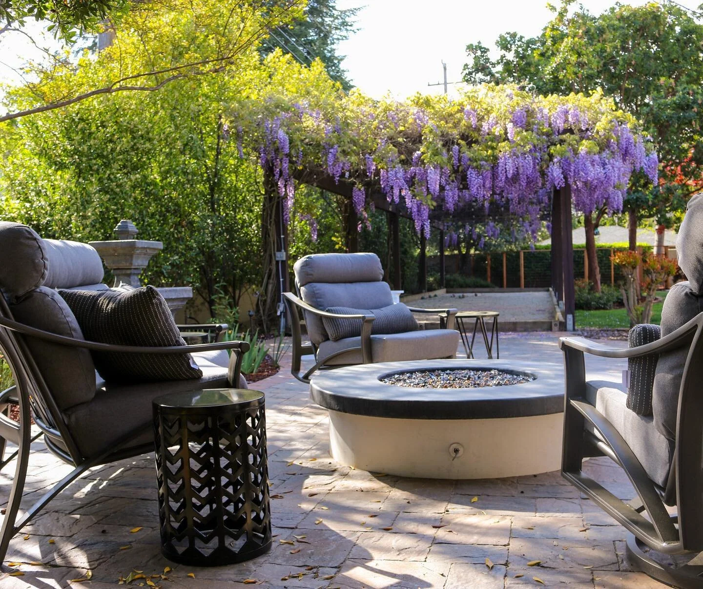 Seating for a bar and grill is just as important as the structure itself. #outdoordining #firepit #backyardoasis #outdoorseating #landscapearchitecture