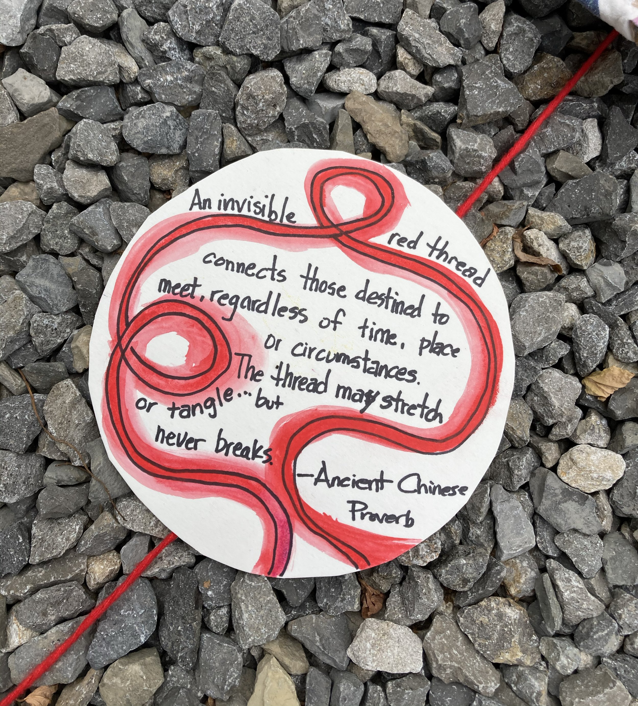 red thread quote on rocks.jpg