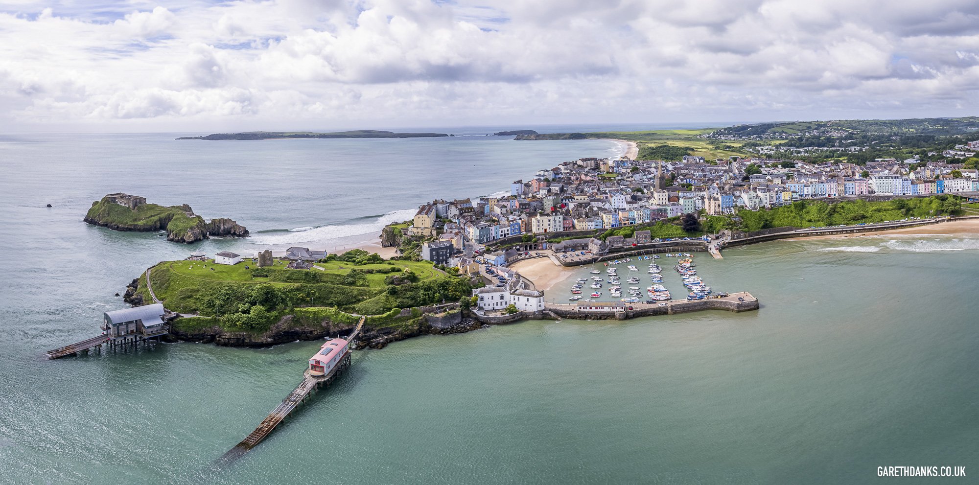 Panoramic drone photograph of Tenby Harbour, with soft light and a cloudy sky. Taken while capturing images for a property survey. of a house on the harbour.