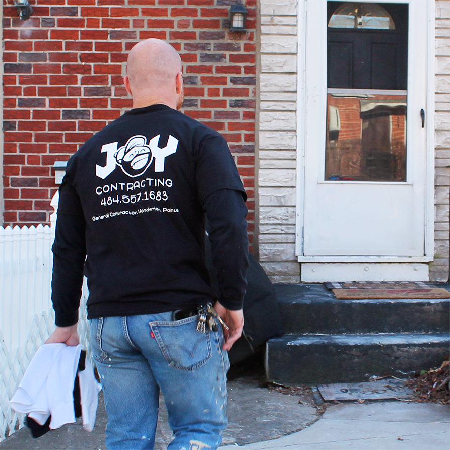 Joy Contracting - black shirt image 2.png