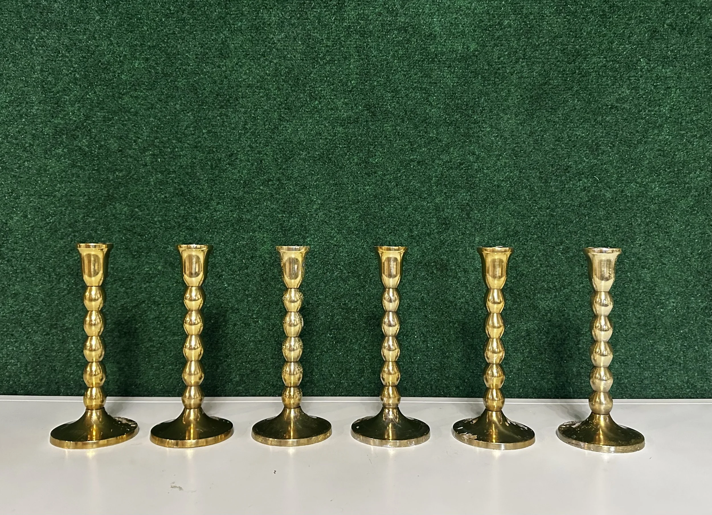 Set of six vintage brass taper candle holders with bulb stems for wedding table decor rental in Kennewick, Pasco, and Richland, WA.
