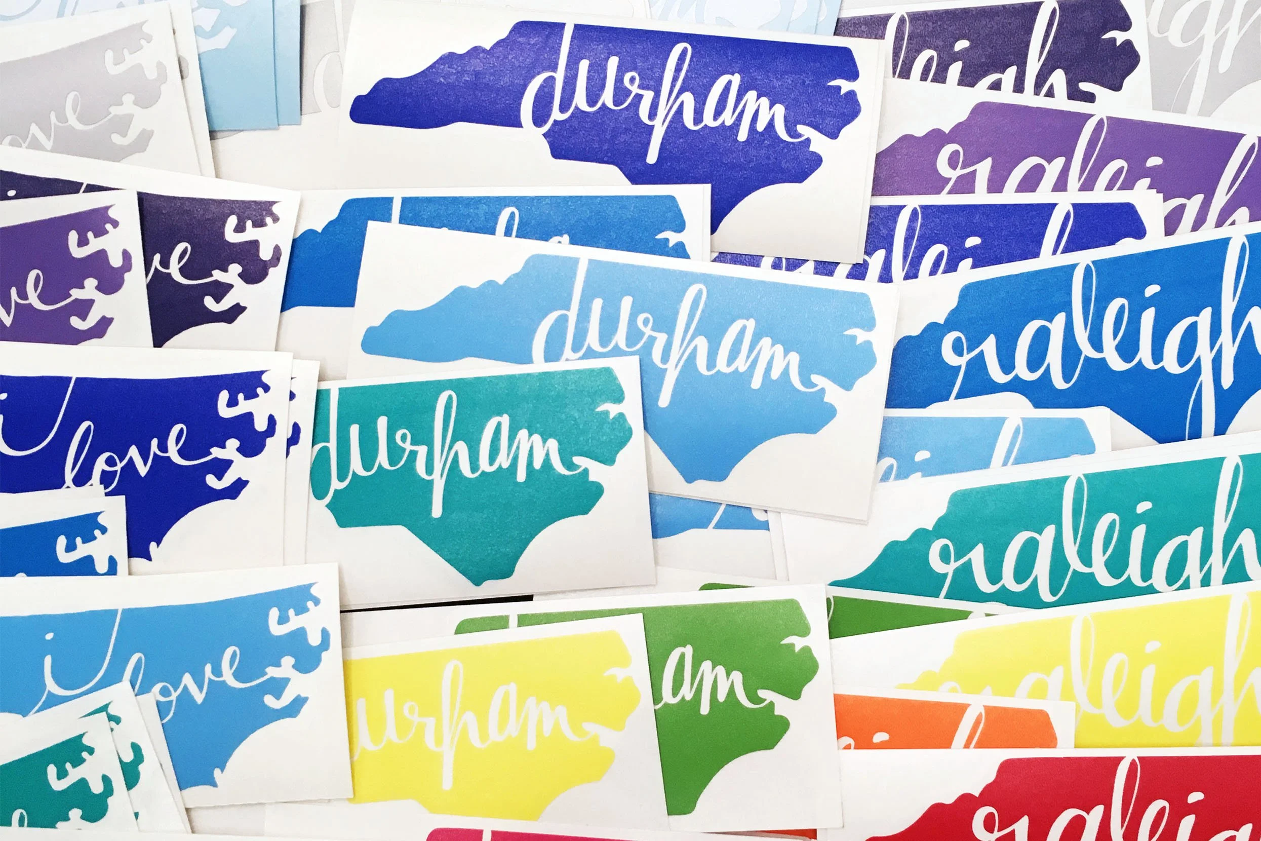 Assortment of colorful north carolina decals for Durham, Raleigh, and Love