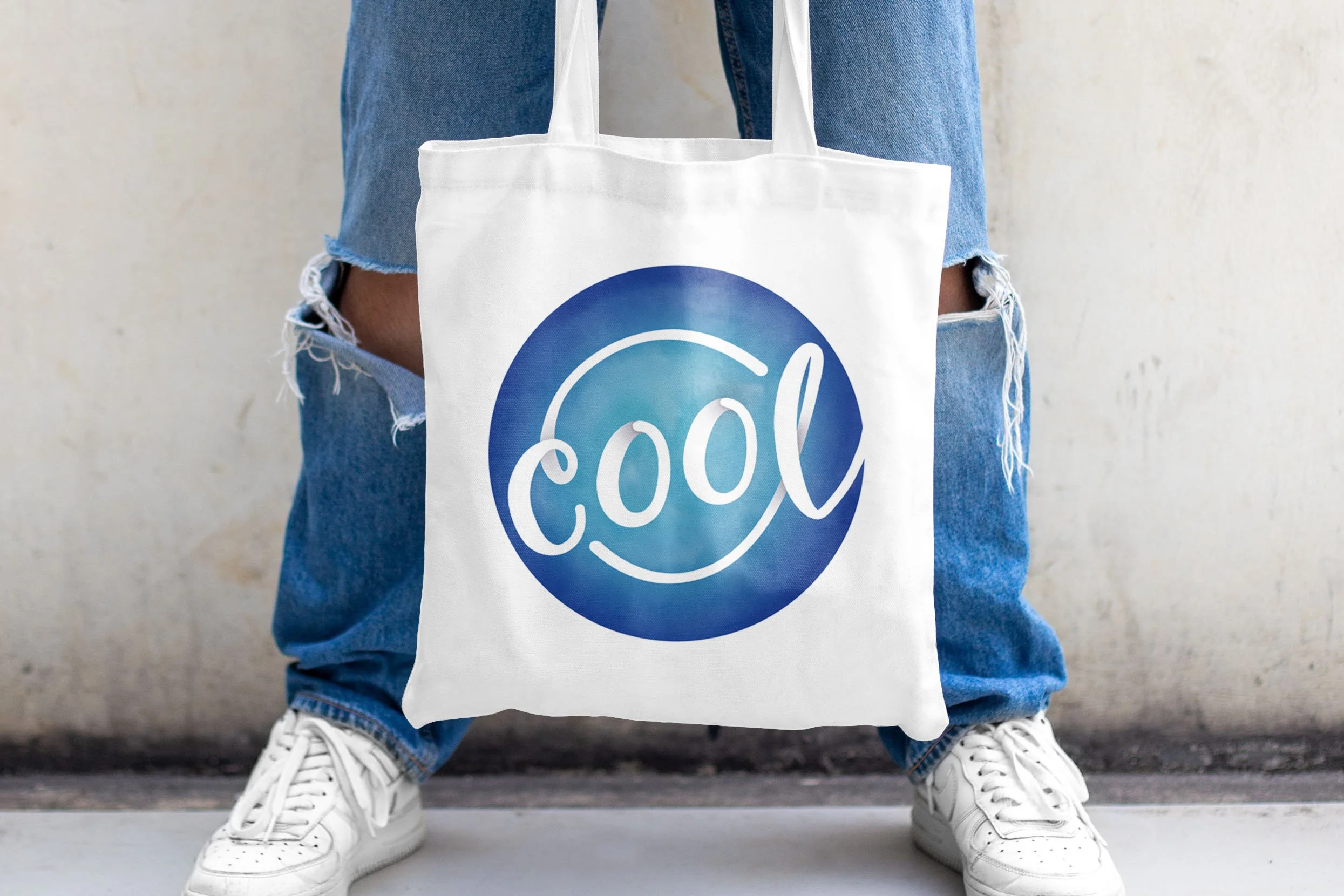 Tote bag featuring a lettering design with the word cool in a blue color scheme.
