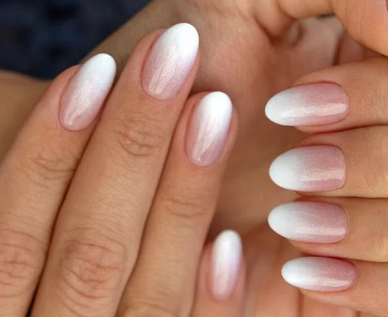 Gel nail extensions at Nail Fairy NYC — long almond shape with glossy nude gel finish