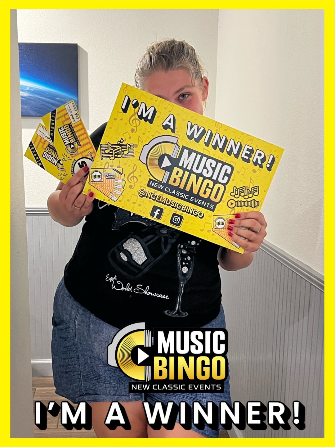 Person holding up multiple bingo cards at a music bingo event, with the cards and a graphic overlay indicating they are winners.
