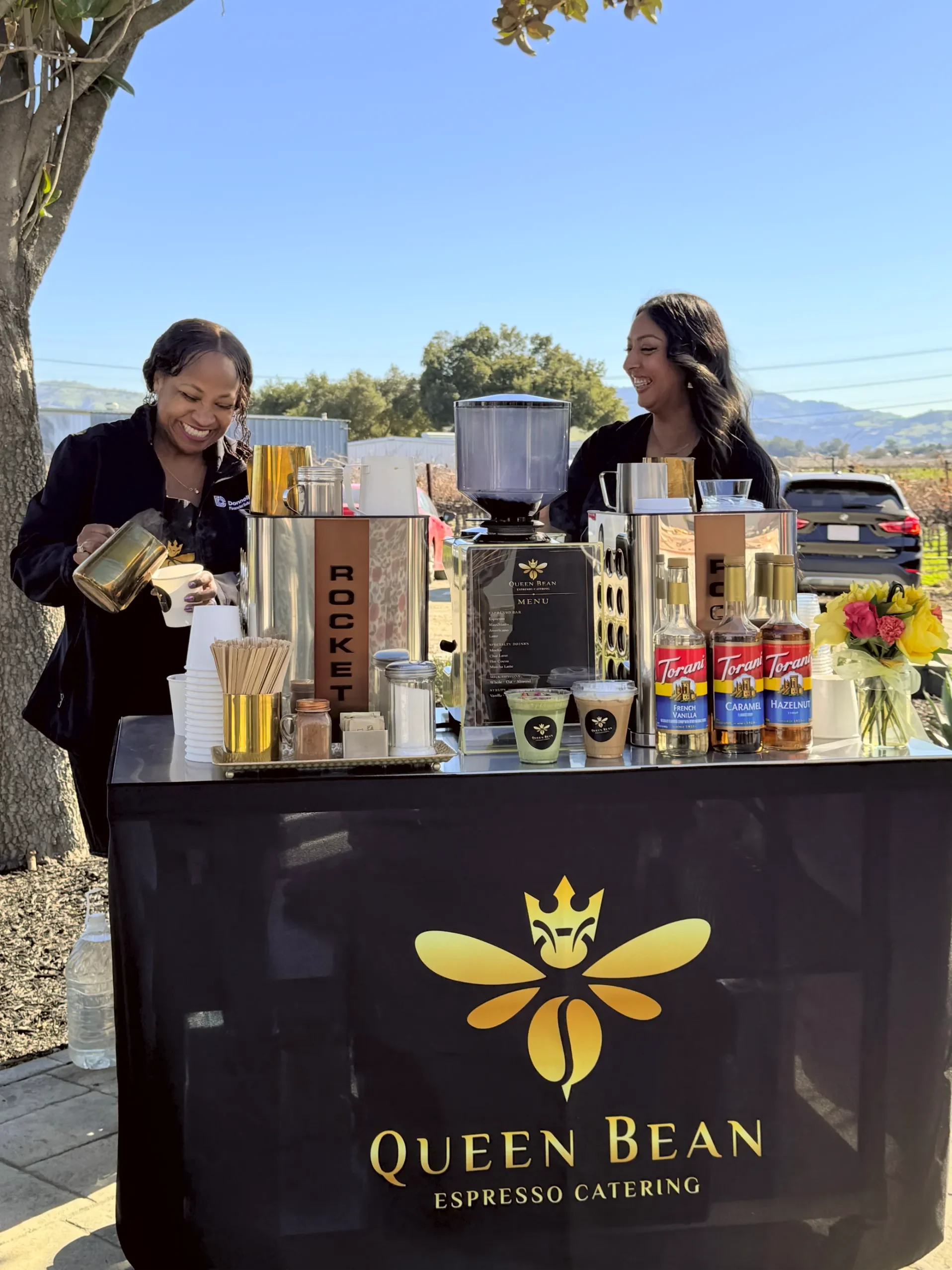 QBEC 2026 - Product - Drinks - Coffee + Matcha - Outdoors - Cart & Baristas Smiling - adjtu_crop_1916x2557_80q - IMG_0320.webp