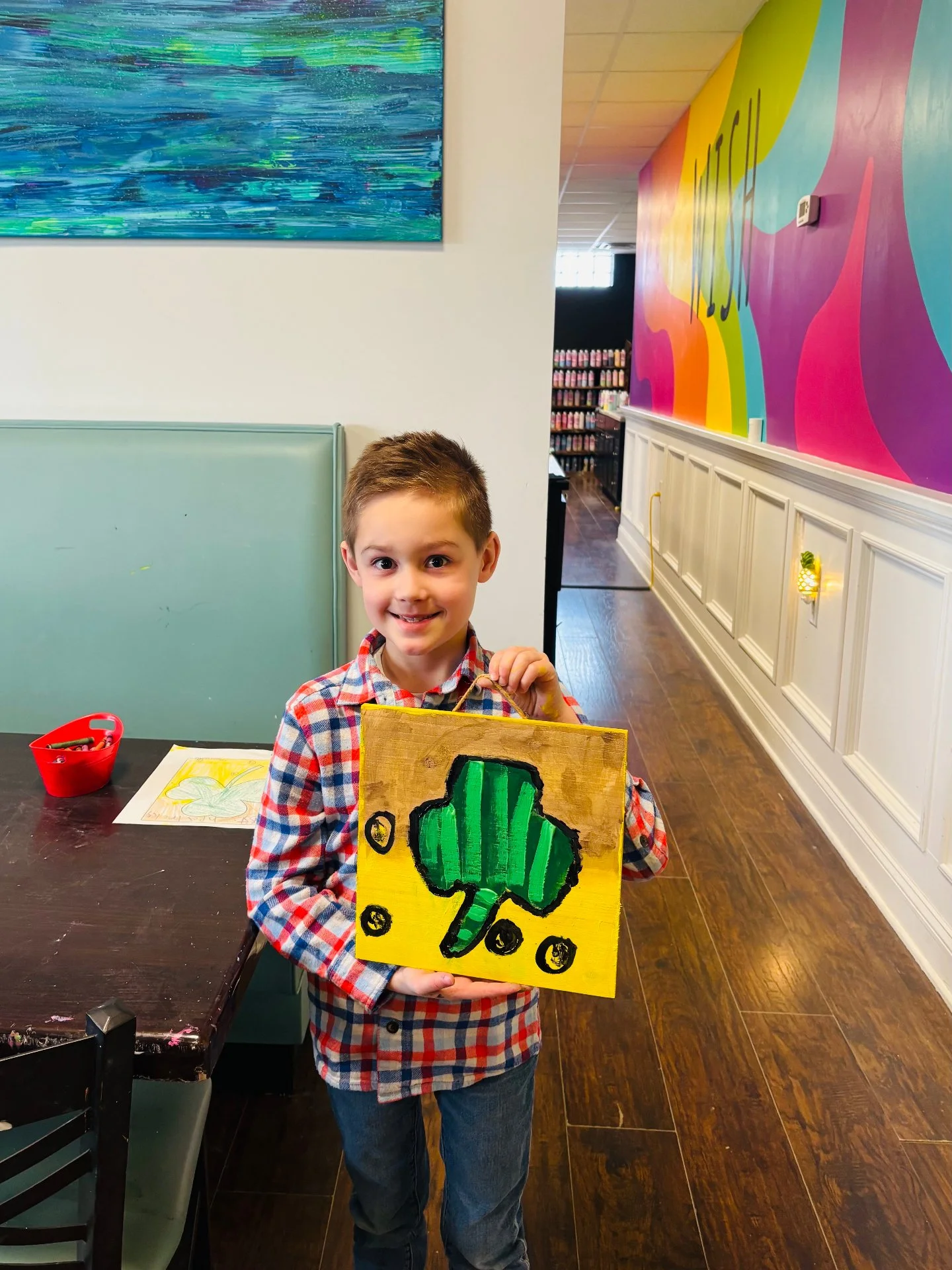 Henry, one of our art club students, showing off the board art he made ☘️ Have a lucky and happy St. Pat's Day 🌈