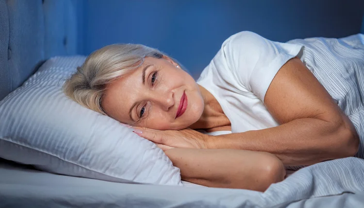 Woman sleeping peacefully at night after hypnotherapy for insomnia