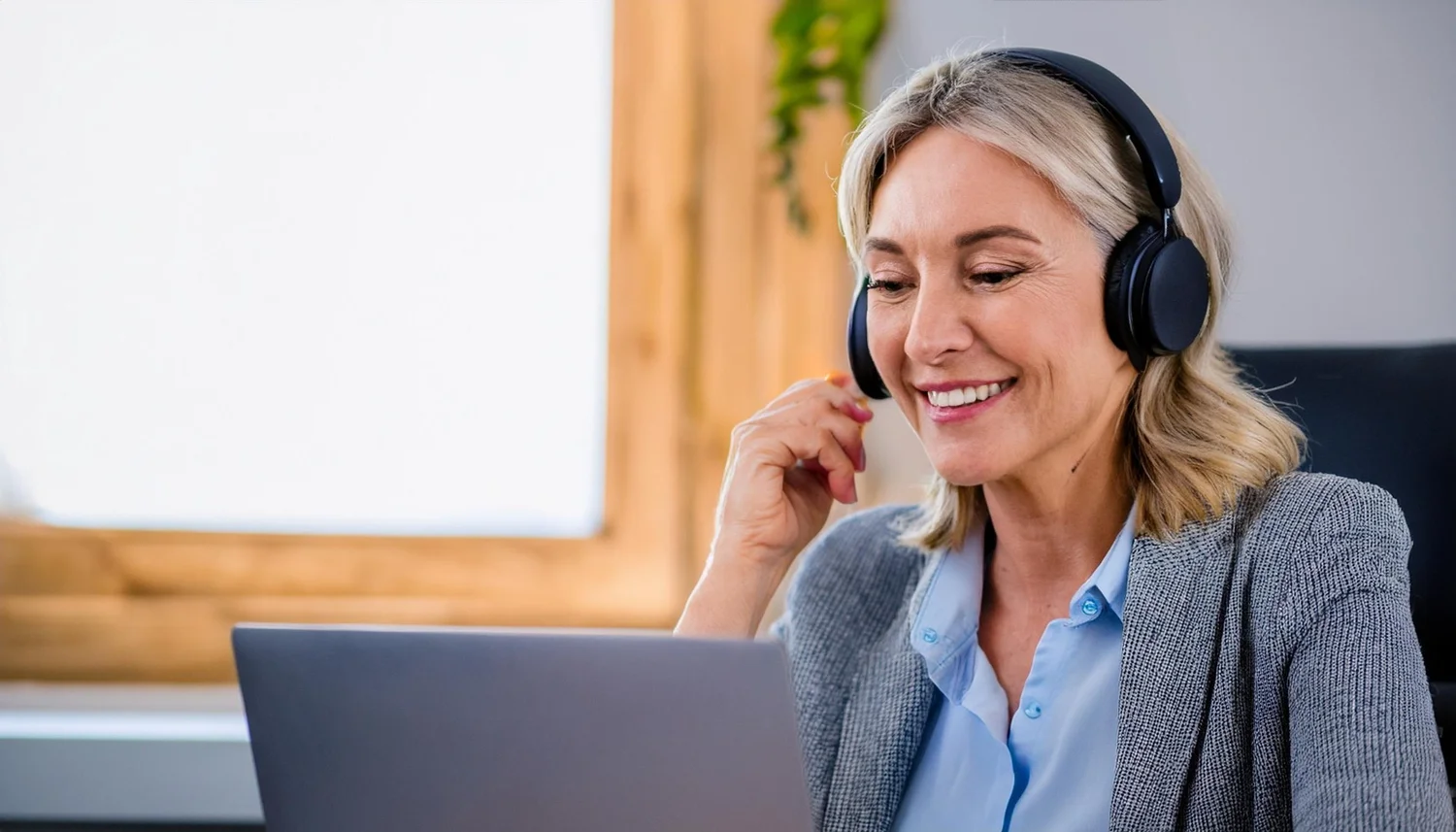 A woman in a calm therapy session, listening through headphones
