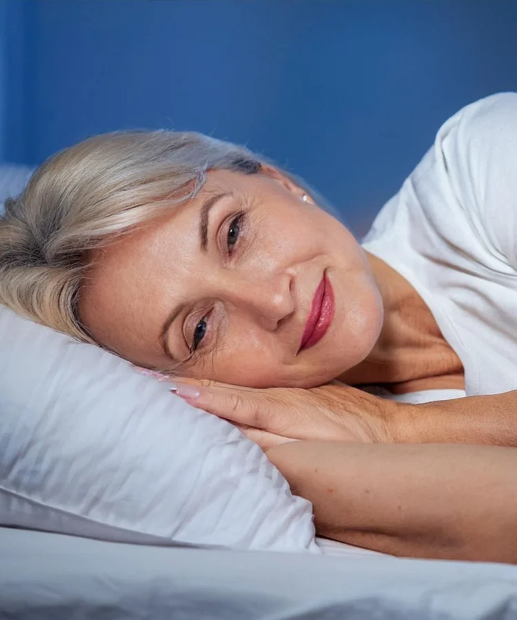 A woman sleeping peacefully after hypnotherapy for sleep